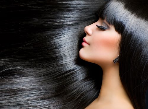An example of a woman with good hair care with long, jetblack, shiny, healthy, full hair