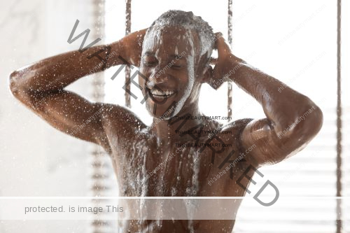 Black man with short curly hair enjoying a shower, shampoo, and bodywash