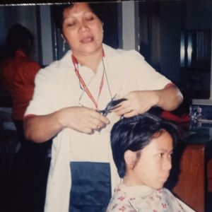 Mila, the veteran beauty cosmetics professional, while cutting and styling the hair of her client (300x300px)