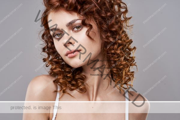 Perm hair with brown color on a serious looking woman