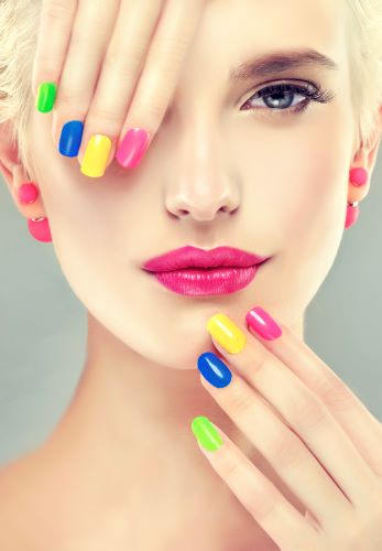 Bright and multi colored summer nails on short-blonde-haired woman