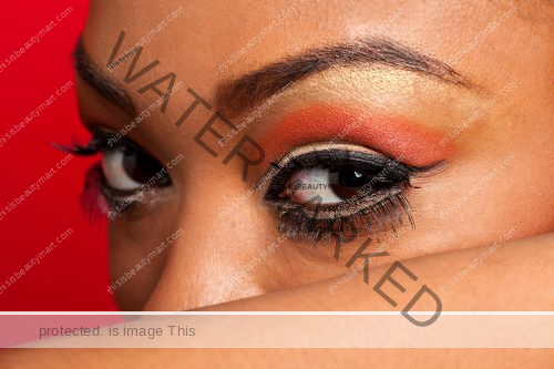 Long eyelashes side eye glance with orange eyeshadow