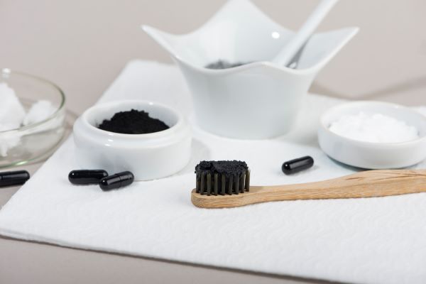 Organic home whitening kit using black charchoal, bamboo toothbrush, and baking soda